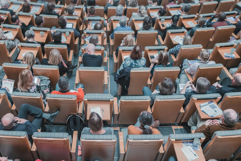 Image: Students are seated in an almost-full lecture hall